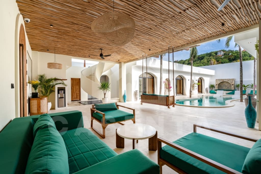 Outdoor seating by the pool of a Villa investment in Bali